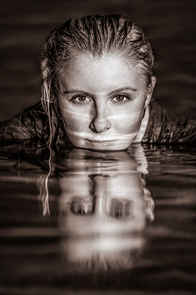 A monochrome headshot of a woman in the water.