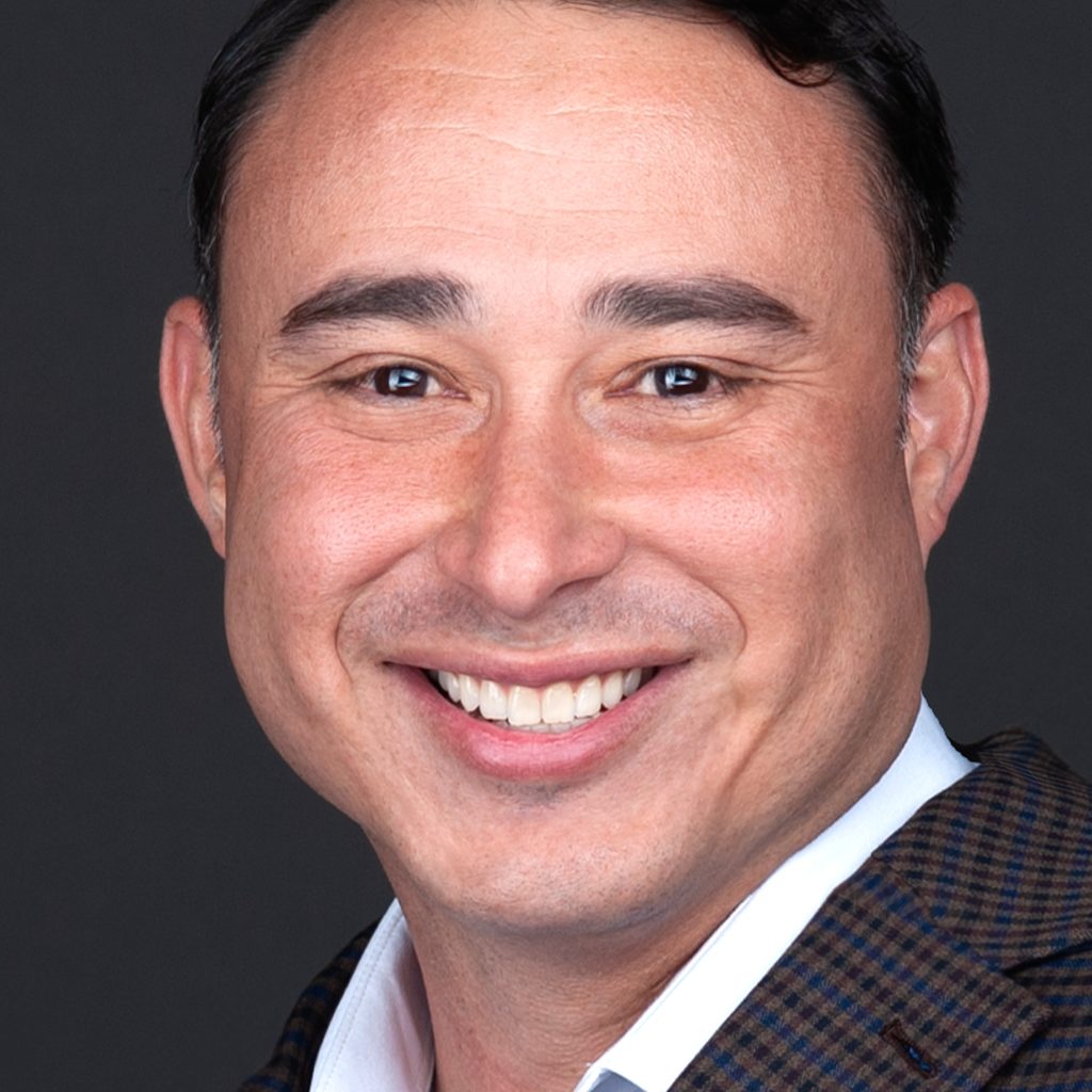 A man in a brown suit smiling for the camera during his corporate headshot session with Sarah Anne Wilson Photography in Cary, North Carolina.