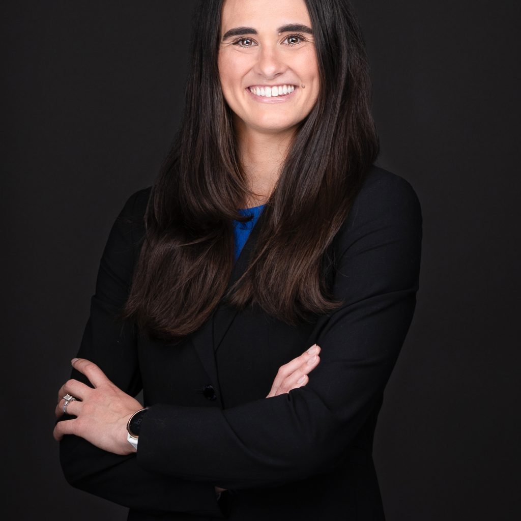 A woman in a black suit and blue dress posing for a photo captured by professional photographer Sarah Anne Wilson Photography near Cary North Carolina.