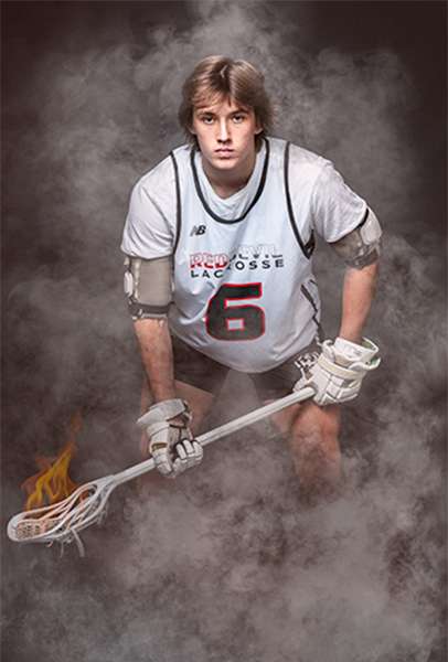 Sarah Anne Wilson Photography captured a lacrosse player holding a lacrosse stick during a personal branding session in Cary, North Carolina.