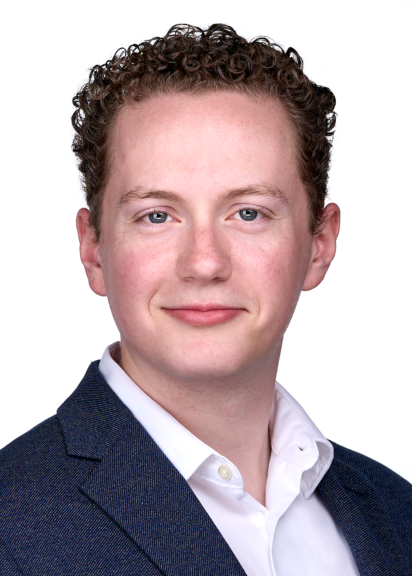 Young man with curly hair and a blue jacket sits for a dating profile headshot in Cary NC