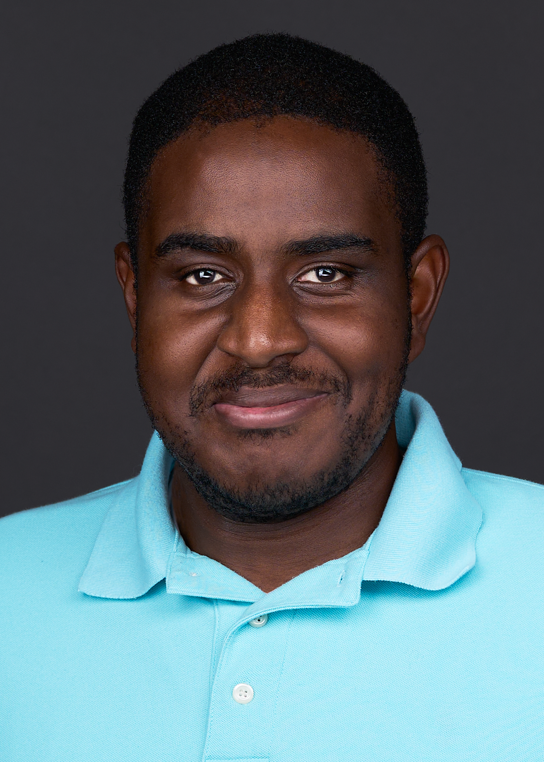 A young man showcases a slight smirk when posing for Cary photographer Sarah Anne Wilson.