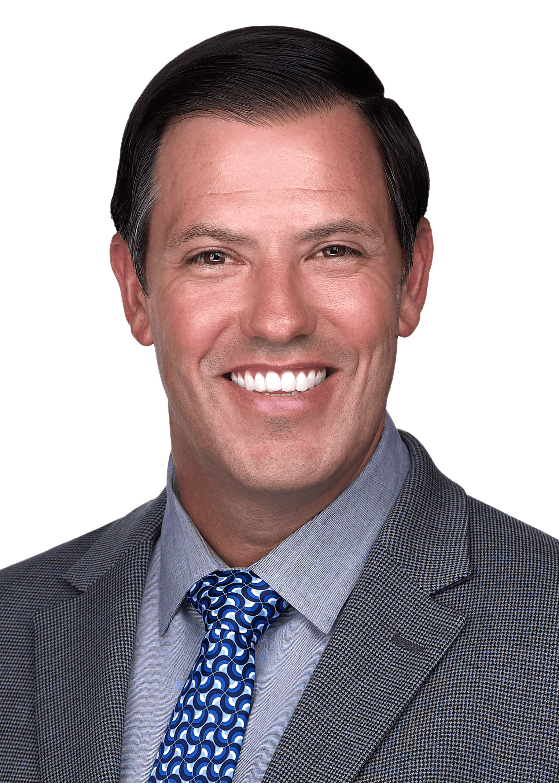 A business man sits for a professional headshot as a Cary photographer captures his warm smile