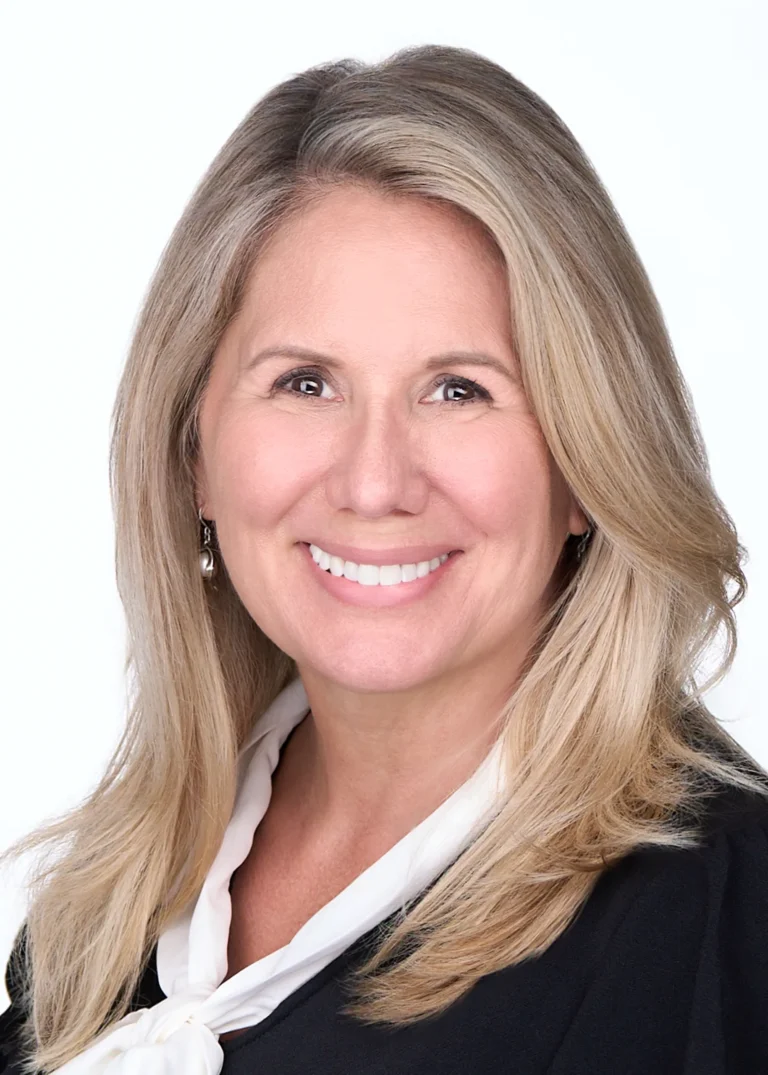 A woman with blonde hair is photographed for her Linkedin profile headshot in Raleigh Nc
