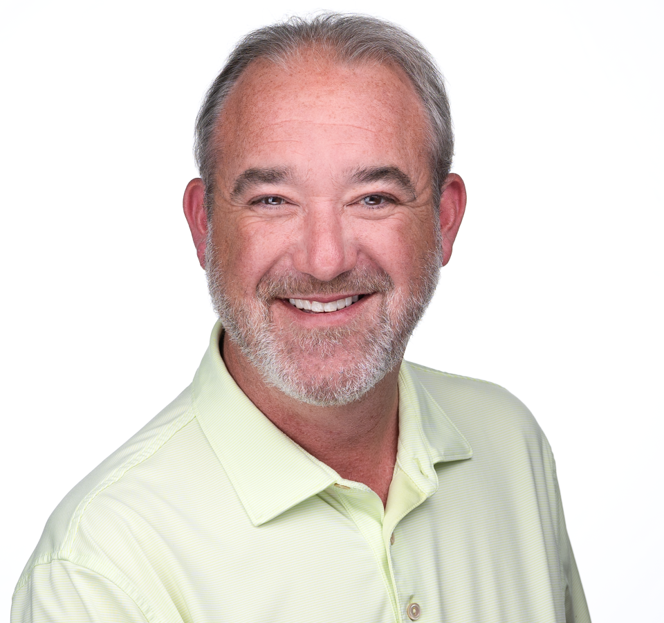 Bill sat for a personal branding headshot wearing a pastel green shirt and a warm smile