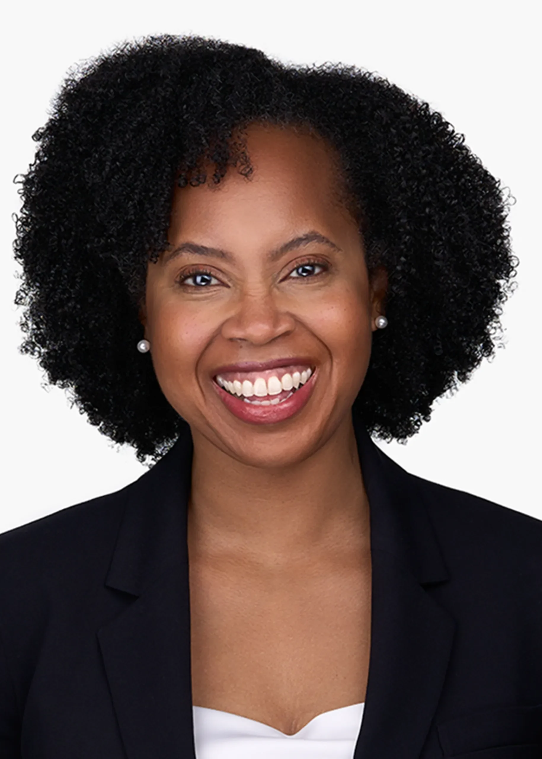 A women with a beautiful smile, dressed in a black suit and white blouse poses for an office headshot in Cary NC